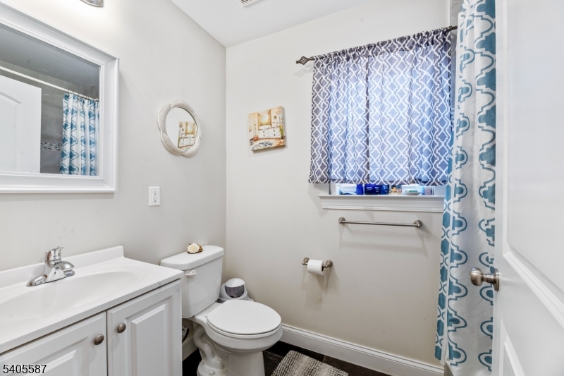 14 Spencer Street Elizabeth, NJ 07202 - Photo 24 of 39 a bathroom with a sink a toilet and a mirror