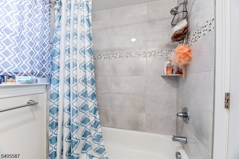 14 Spencer Street Elizabeth, NJ 07202 - Photo 25 of 39 a bathroom with a shower curtain
