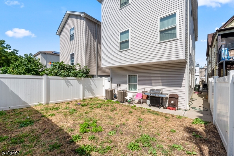 14 Spencer Street Elizabeth, NJ 07202 - Photo 34 of 39 a view of a house with backyard and sitting area