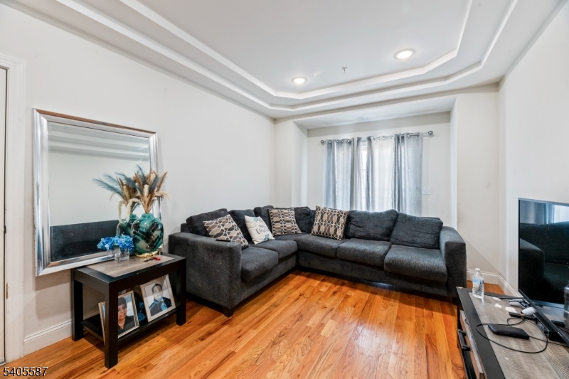 14 Spencer Street Elizabeth, NJ 07202 - Photo 5 of 39 a living room with furniture and a flat screen tv