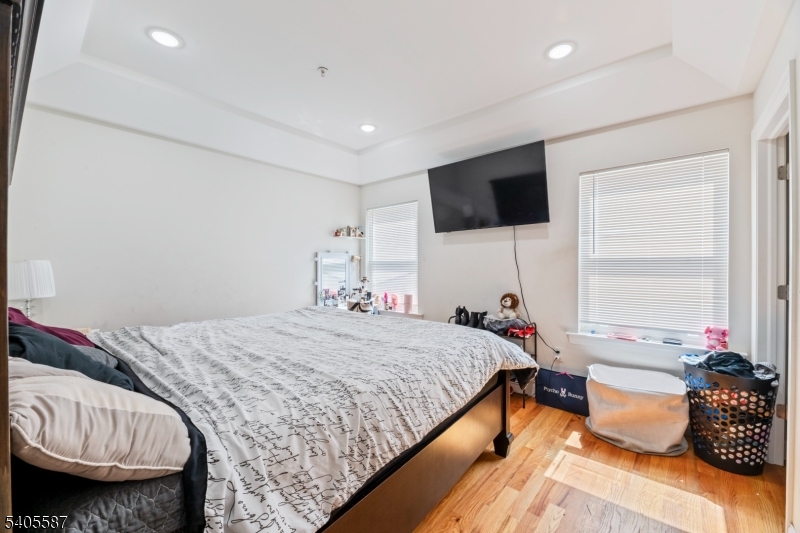 14 Spencer Street Elizabeth, NJ 07202 - Photo 10 of 39 a bedroom with a bed and a flat screen tv