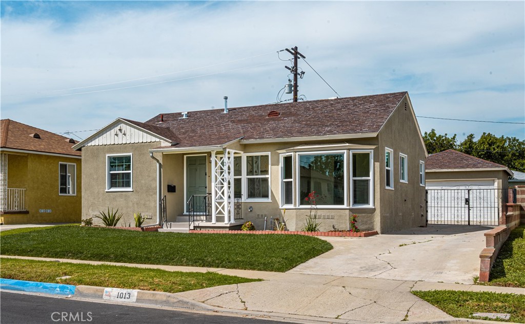 1013 West 138th Street Compton, CA 90222 - Photo 30 of 30 a front view of a house with a garden and plants