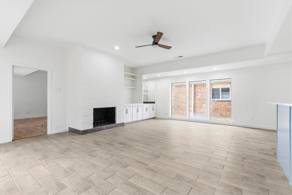 17003 Davenport Road Dallas, TX 75248 - Photo 7 of 40 a view of an empty room with a fireplace and a window