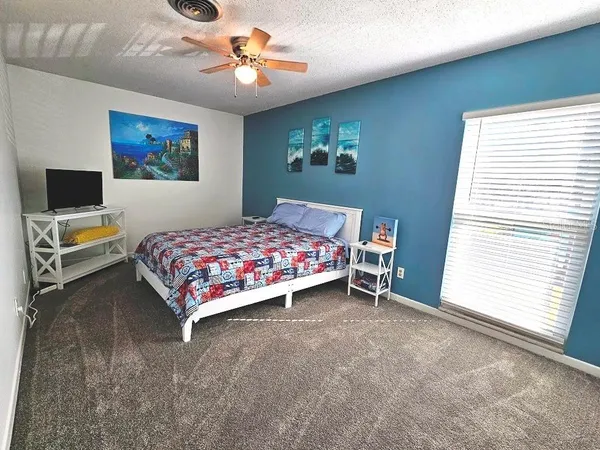 a bedroom with a bed and a chandelier