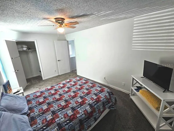 a bedroom with a bed and a flat screen tv