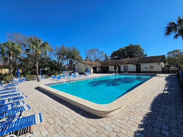 a view of a swimming pool with an outdoor seating and a yard