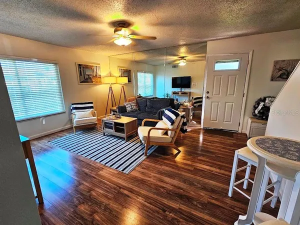 a living room with furniture and a wooden floor