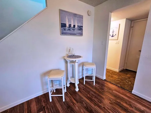 a dining room with furniture and wooden floor