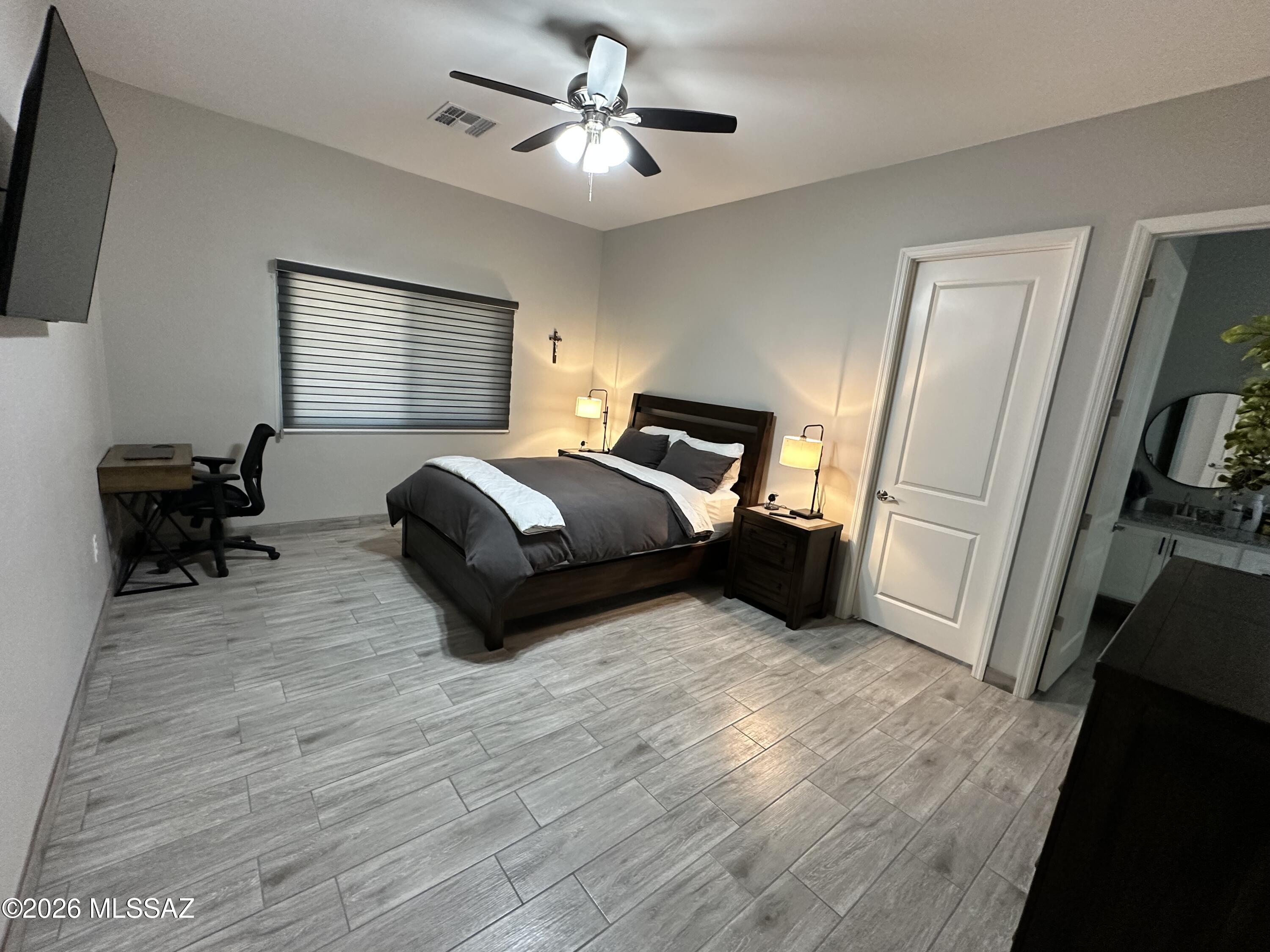 117 Ver Patria Rio Rico, AZ 85648 - Photo 18 of 28 a bedroom with a bed and a chandelier