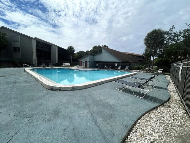 a view of a swimming pool with a yard