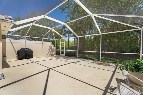 a view of an outdoor sitting area with table and chairs
