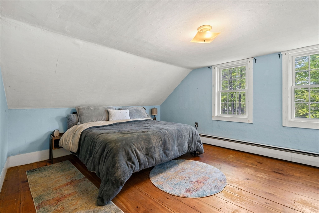 600 Main Street Ashby, MA 01431 - Photo 23 of 40 a spacious bedroom with a bed and window