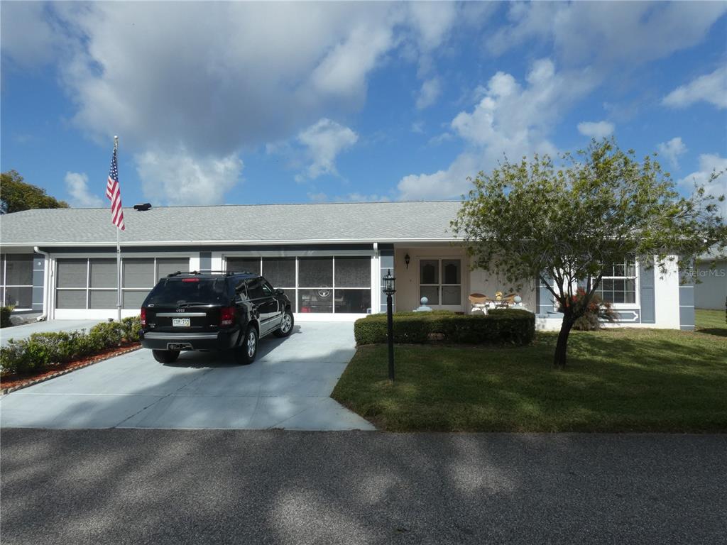 11151 Sandtrap Drive, Unit 11151 Port Richey, FL 34668 - Photo 1 of 33 a view of a car in front of a house
