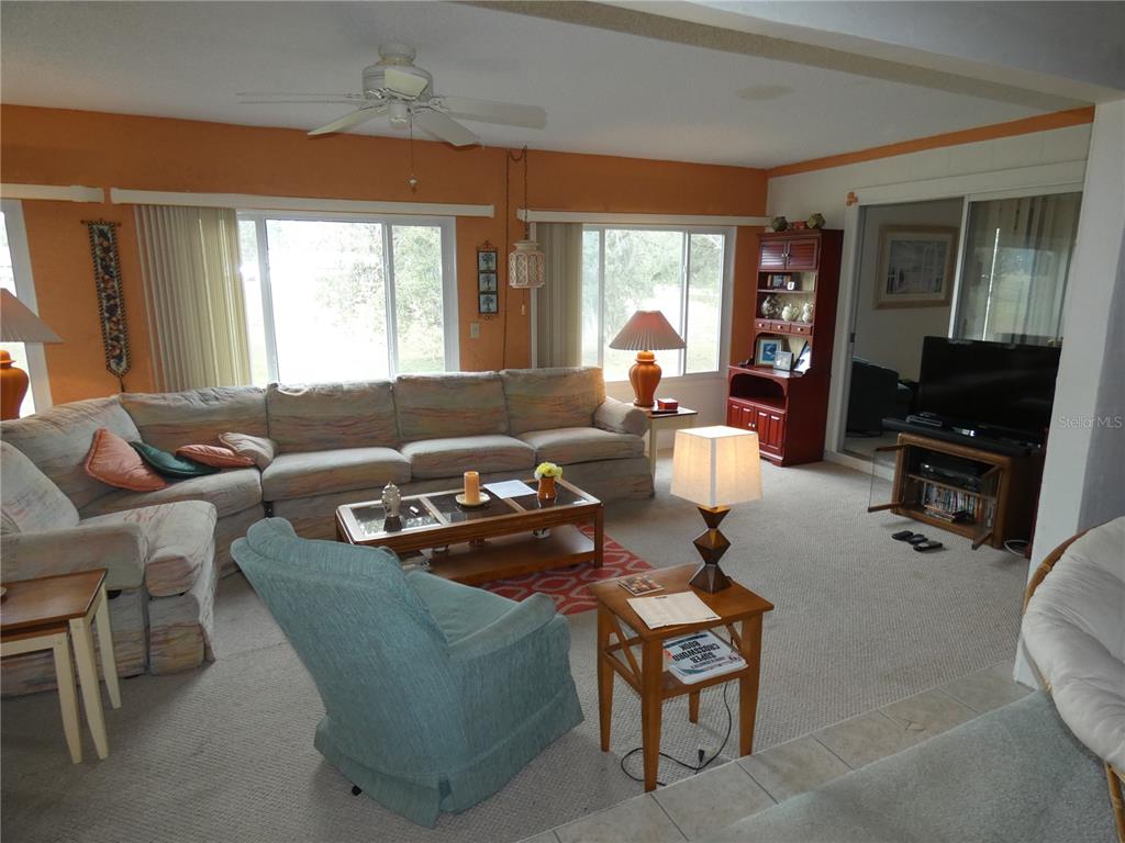 11151 Sandtrap Drive, Unit 11151 Port Richey, FL 34668 - Photo 11 of 33 a living room with furniture and a large window