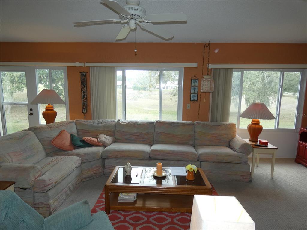 11151 Sandtrap Drive, Unit 11151 Port Richey, FL 34668 - Photo 12 of 33 a living room with furniture and a large window