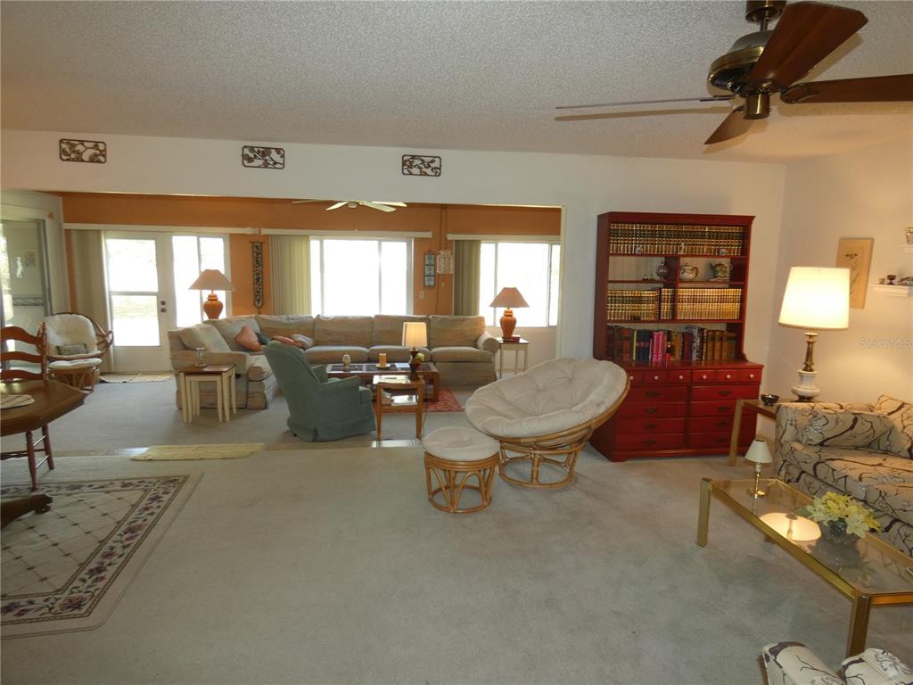 11151 Sandtrap Drive, Unit 11151 Port Richey, FL 34668 - Photo 14 of 33 a living room with furniture and a large window
