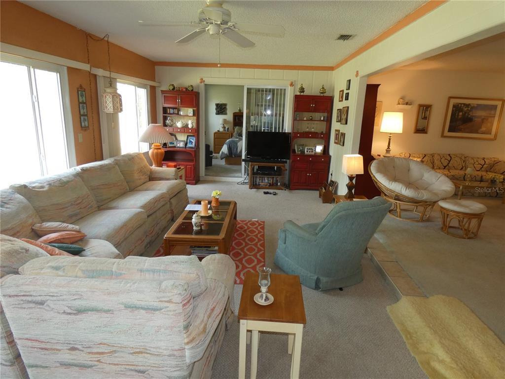 11151 Sandtrap Drive, Unit 11151 Port Richey, FL 34668 - Photo 15 of 33 a living room with furniture and a large window