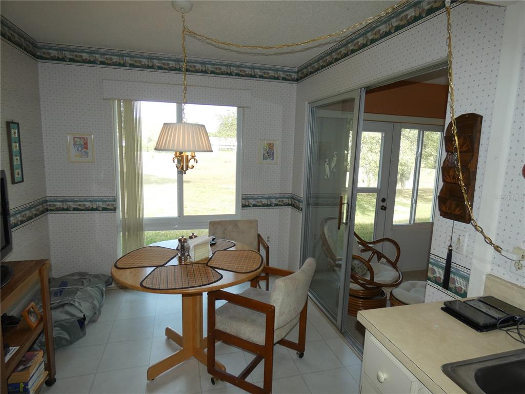 11151 Sandtrap Drive, Unit 11151 Port Richey, FL 34668 - Photo 16 of 33 a dining room with furniture and window