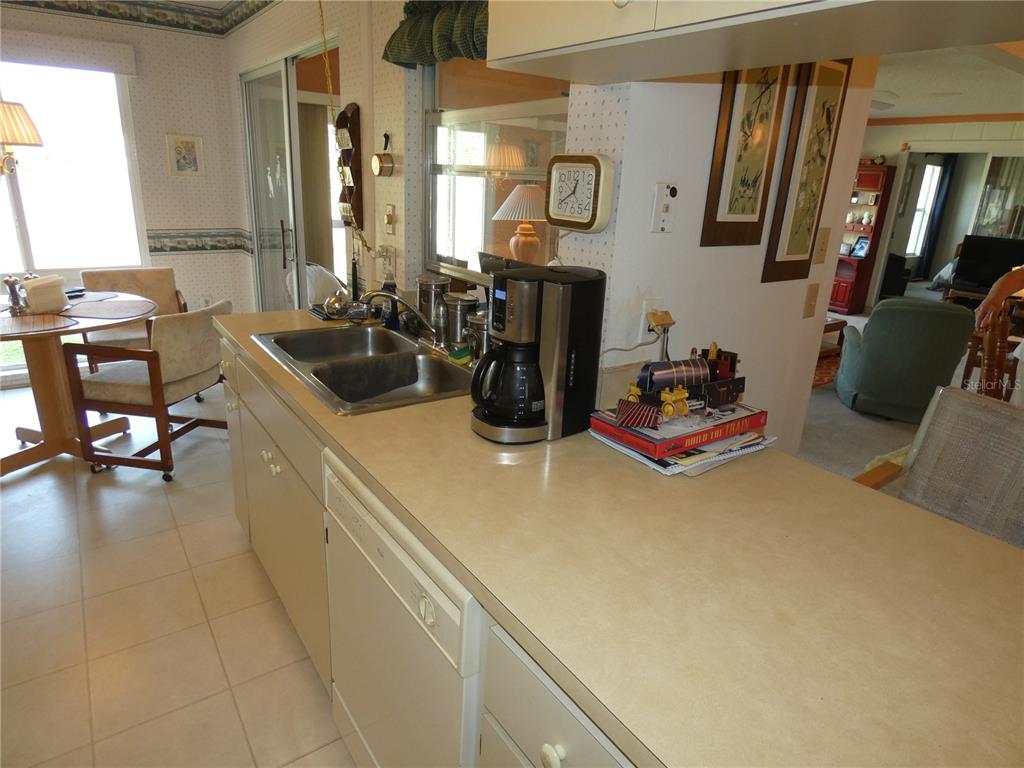 11151 Sandtrap Drive, Unit 11151 Port Richey, FL 34668 - Photo 18 of 33 a kitchen with a refrigerator and a table