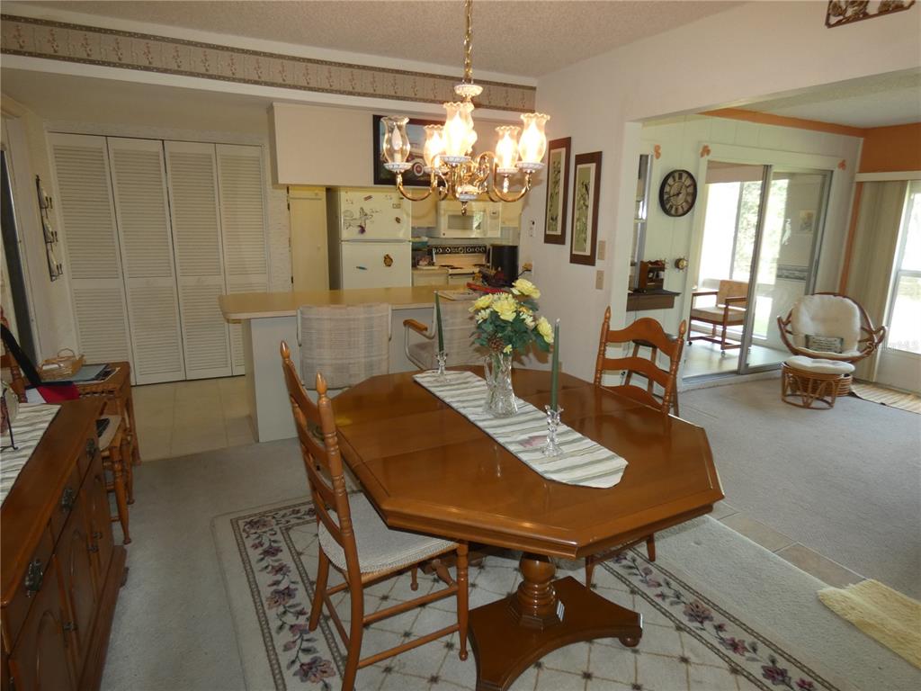 11151 Sandtrap Drive, Unit 11151 Port Richey, FL 34668 - Photo 20 of 33 a view of a dining room with furniture