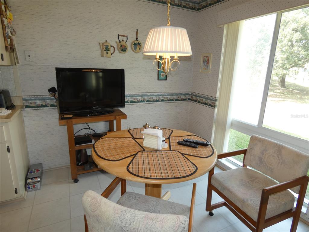 11151 Sandtrap Drive, Unit 11151 Port Richey, FL 34668 - Photo 22 of 33 a living room with furniture and a flat screen tv