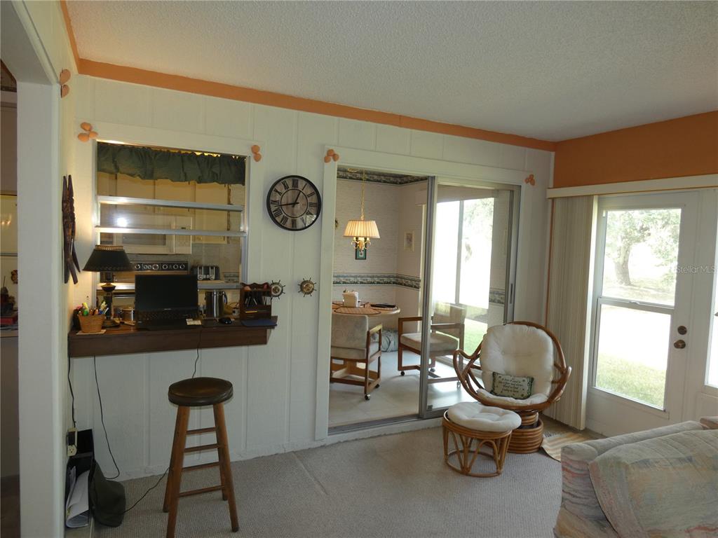 11151 Sandtrap Drive, Unit 11151 Port Richey, FL 34668 - Photo 24 of 33 a living room with furniture and a large window