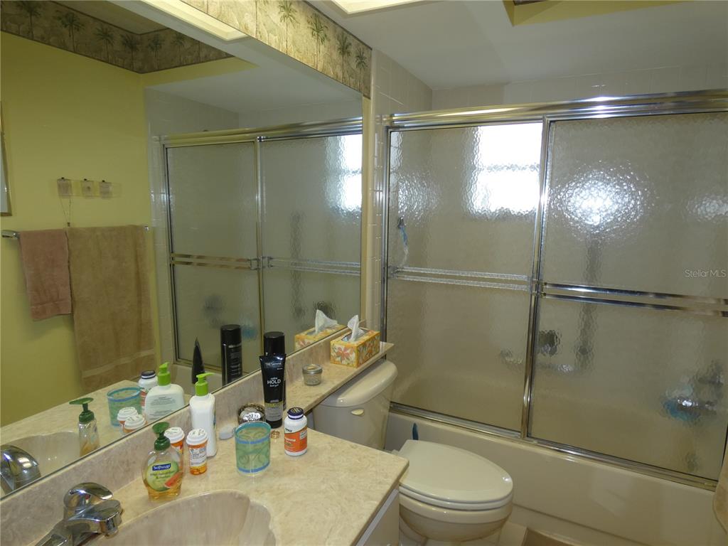11151 Sandtrap Drive, Unit 11151 Port Richey, FL 34668 - Photo 27 of 33 a bathroom with a sink toilet and shower