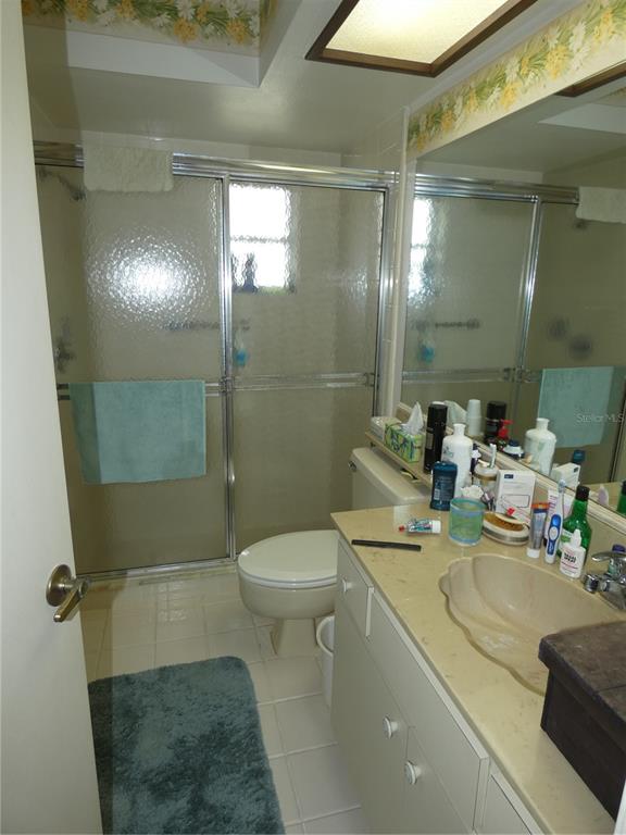 11151 Sandtrap Drive, Unit 11151 Port Richey, FL 34668 - Photo 28 of 33 a bathroom with a sink a toilet and shower