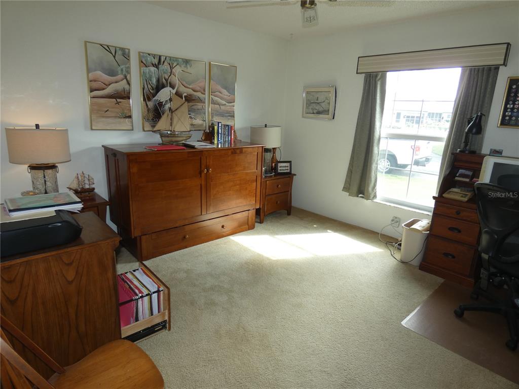 11151 Sandtrap Drive, Unit 11151 Port Richey, FL 34668 - Photo 29 of 33 a living room with furniture and a window