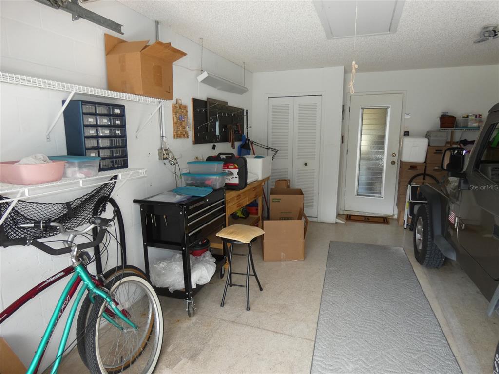 11151 Sandtrap Drive, Unit 11151 Port Richey, FL 34668 - Photo 33 of 33 a livingroom with furniture a flat screen tv and a window