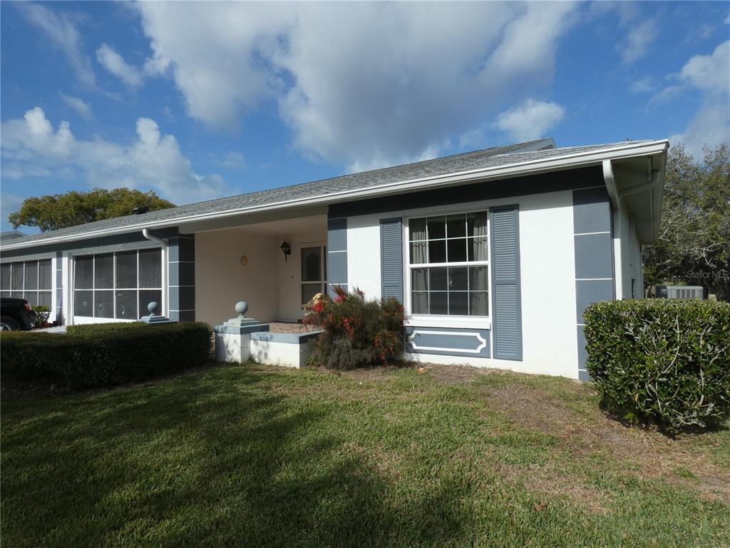 11151 Sandtrap Drive, Unit 11151 Port Richey, FL 34668 - Photo 4 of 33 a front view of a house with a garden