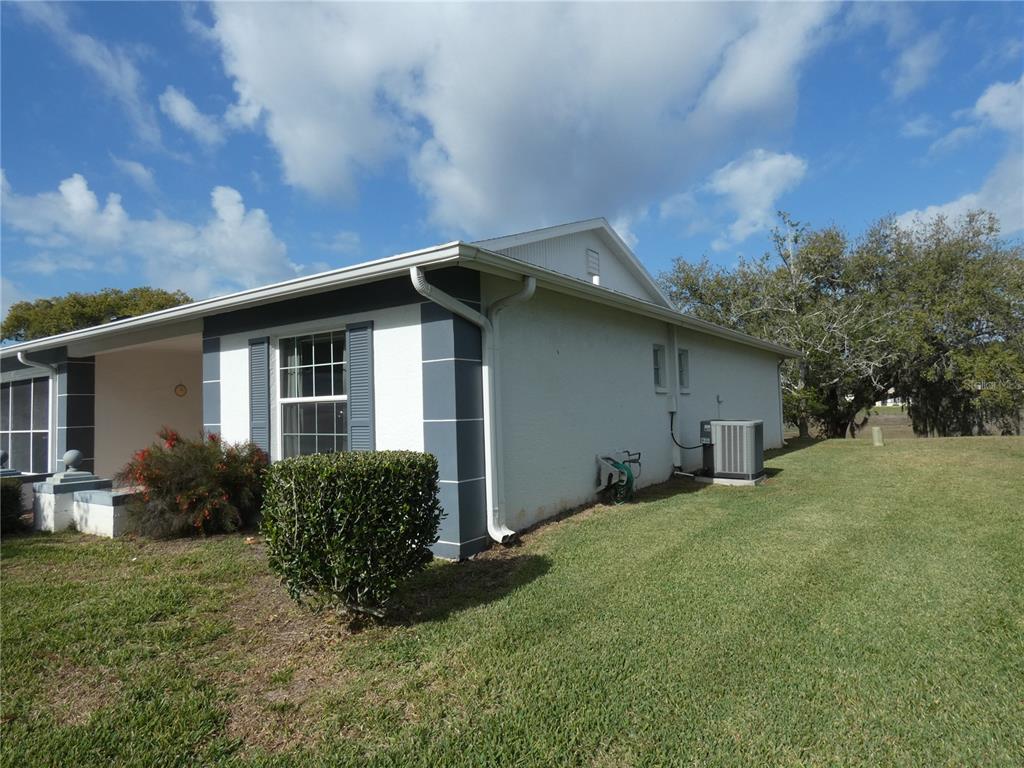 11151 Sandtrap Drive, Unit 11151 Port Richey, FL 34668 - Photo 5 of 33 a house with green field in front of it