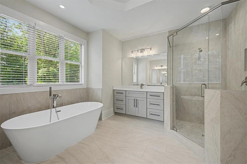 217 Laura Lake Road Marietta, GA 30066 - Photo 35 of 54 a spacious bathroom with a tub sink shower and windows