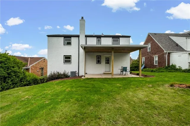 a view of a house with backyard and porch