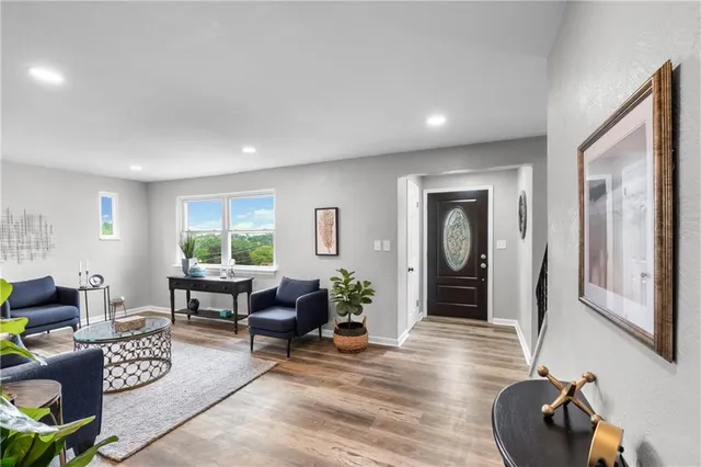 a living room with furniture and wooden floor