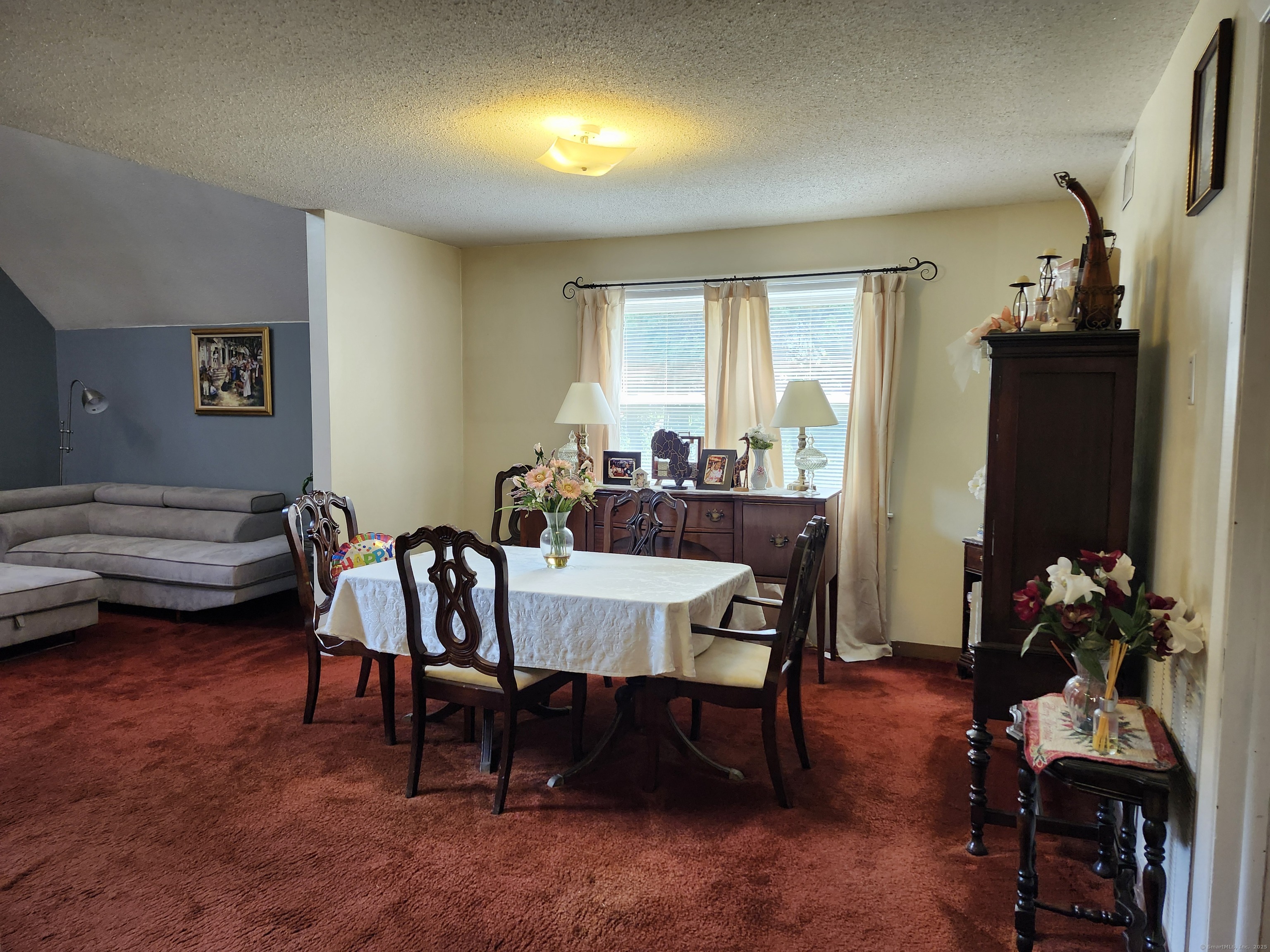 39 Loren Circle Windsor, CT 06095 - Photo 9 of 16 a view of a dining room with furniture and a potted plant