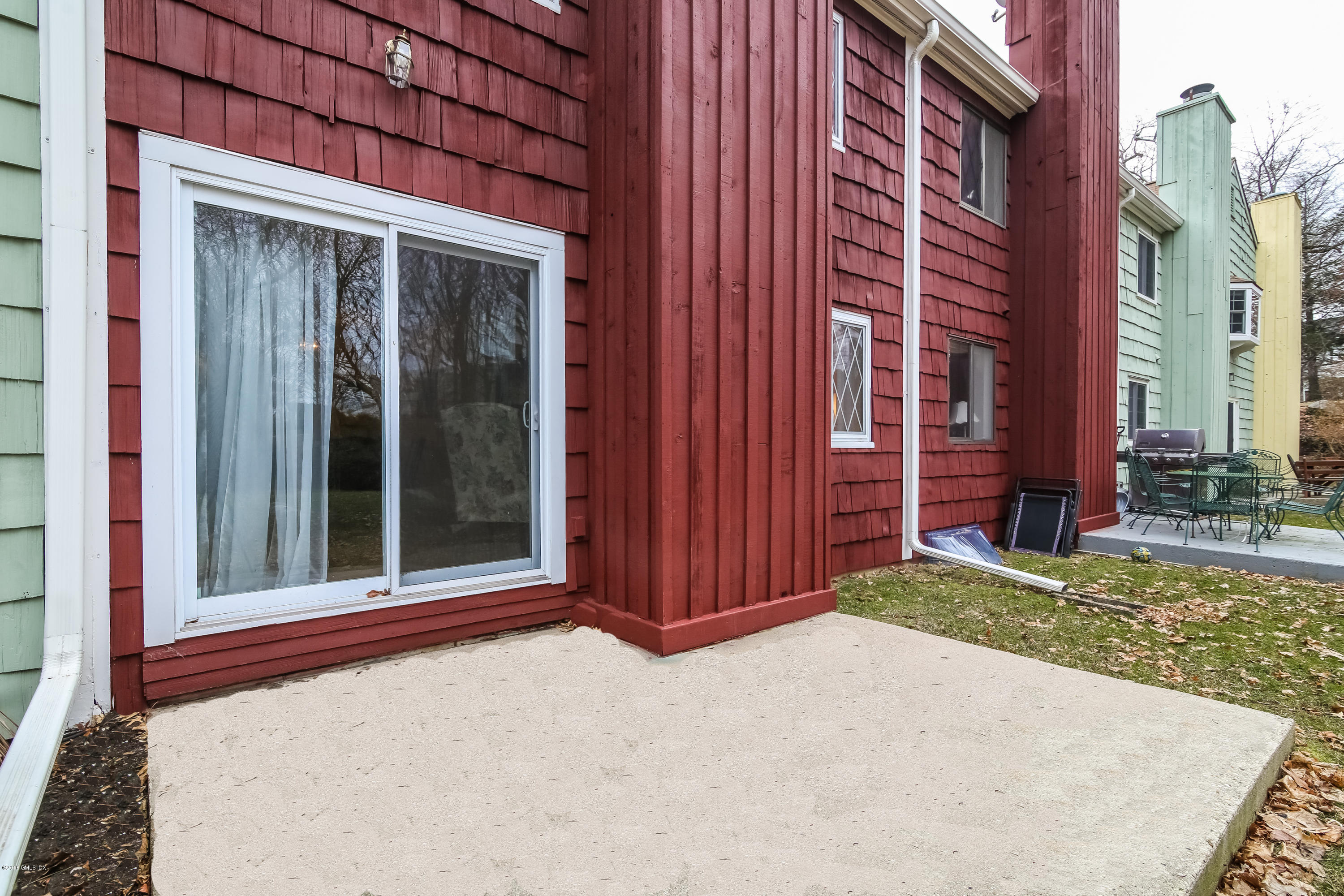 37 Sheep Hill Road, Unit 6 Riverside, CT 06878 - Photo 13 of 18 a view of a house with a door and wooden fence