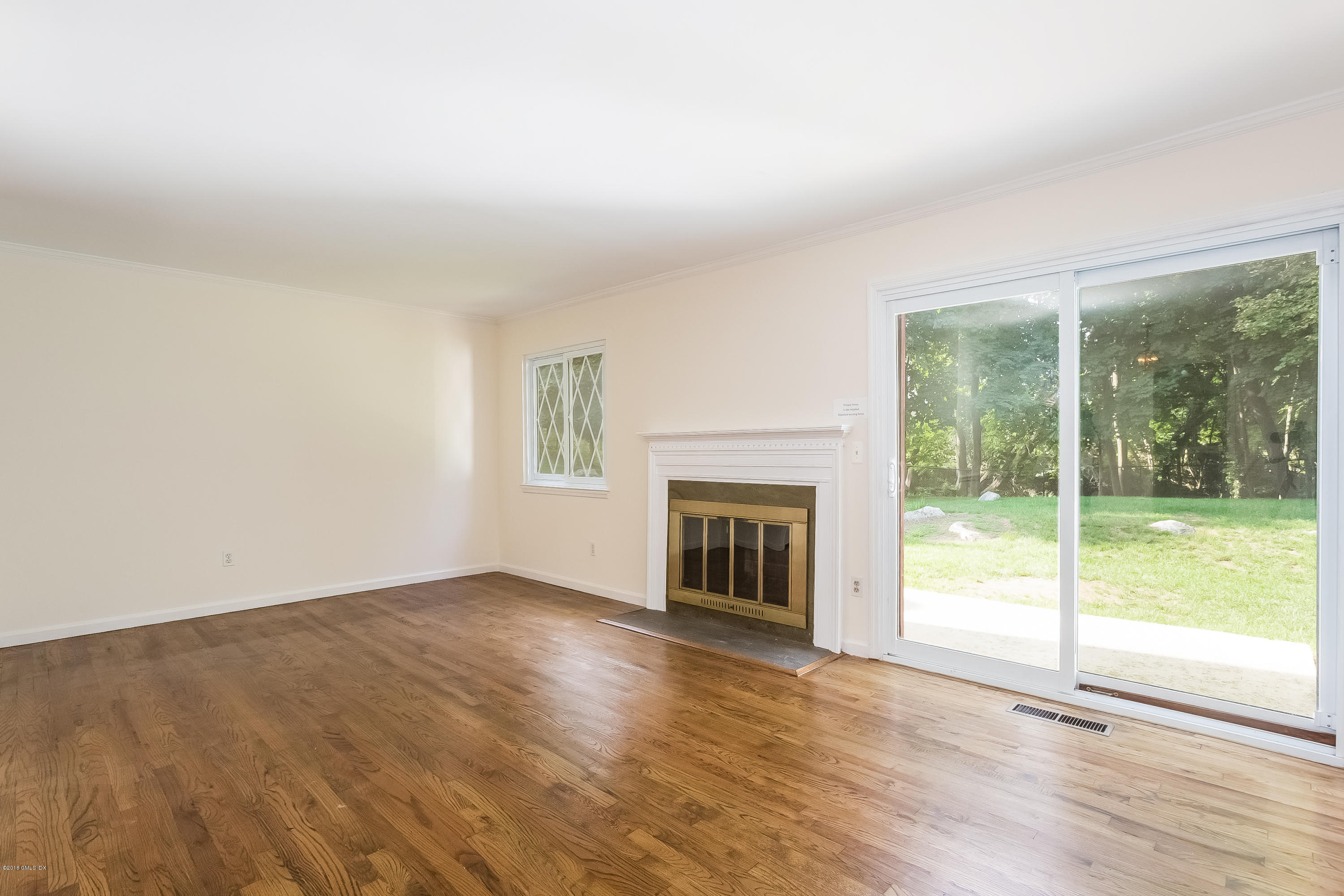 37 Sheep Hill Road, Unit 6 Riverside, CT 06878 - Photo 3 of 18 a view of an empty room with wooden floor and a fireplace