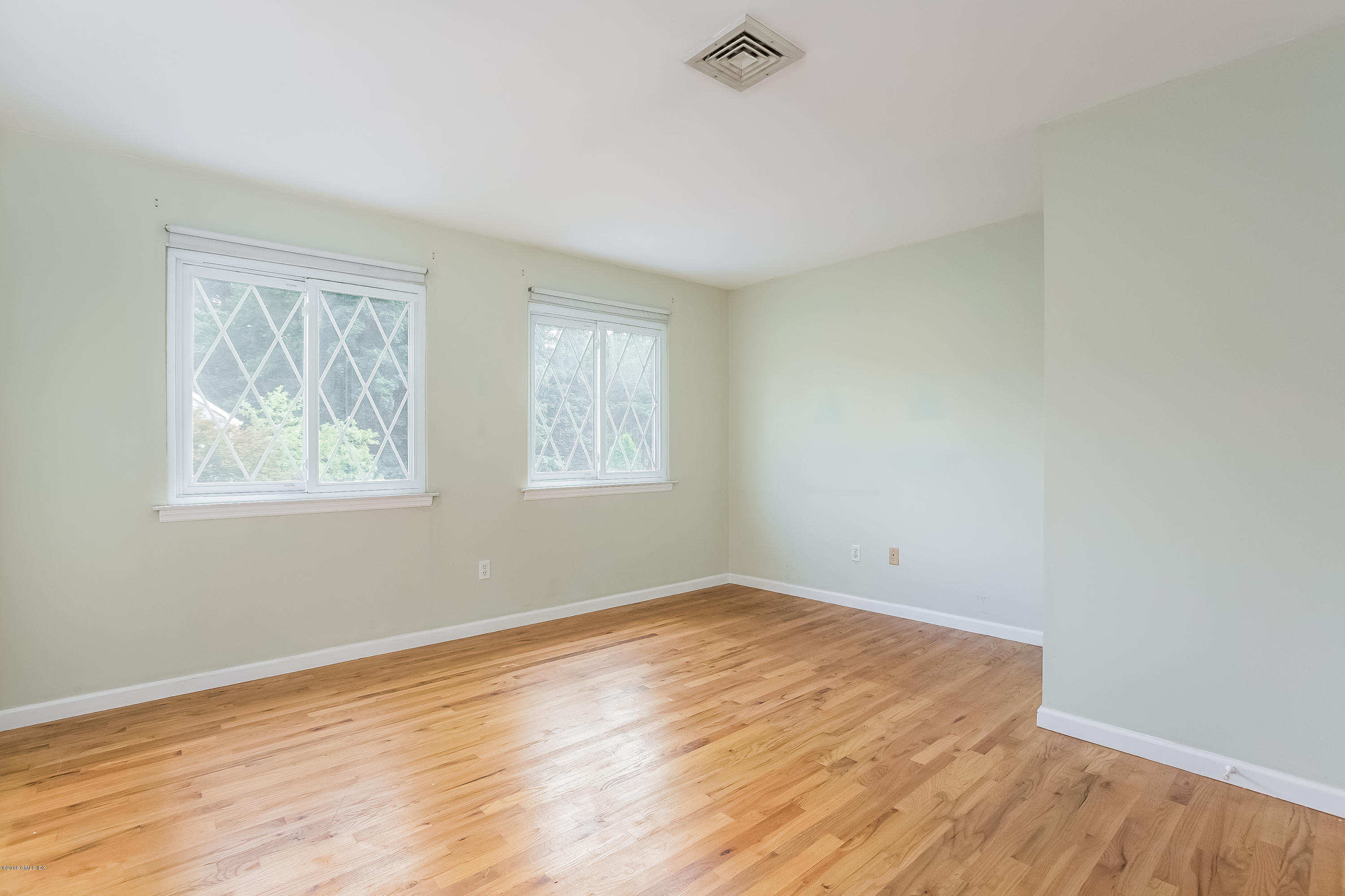 37 Sheep Hill Road, Unit 6 Riverside, CT 06878 - Photo 7 of 18 a view of empty room with wooden floor and fan