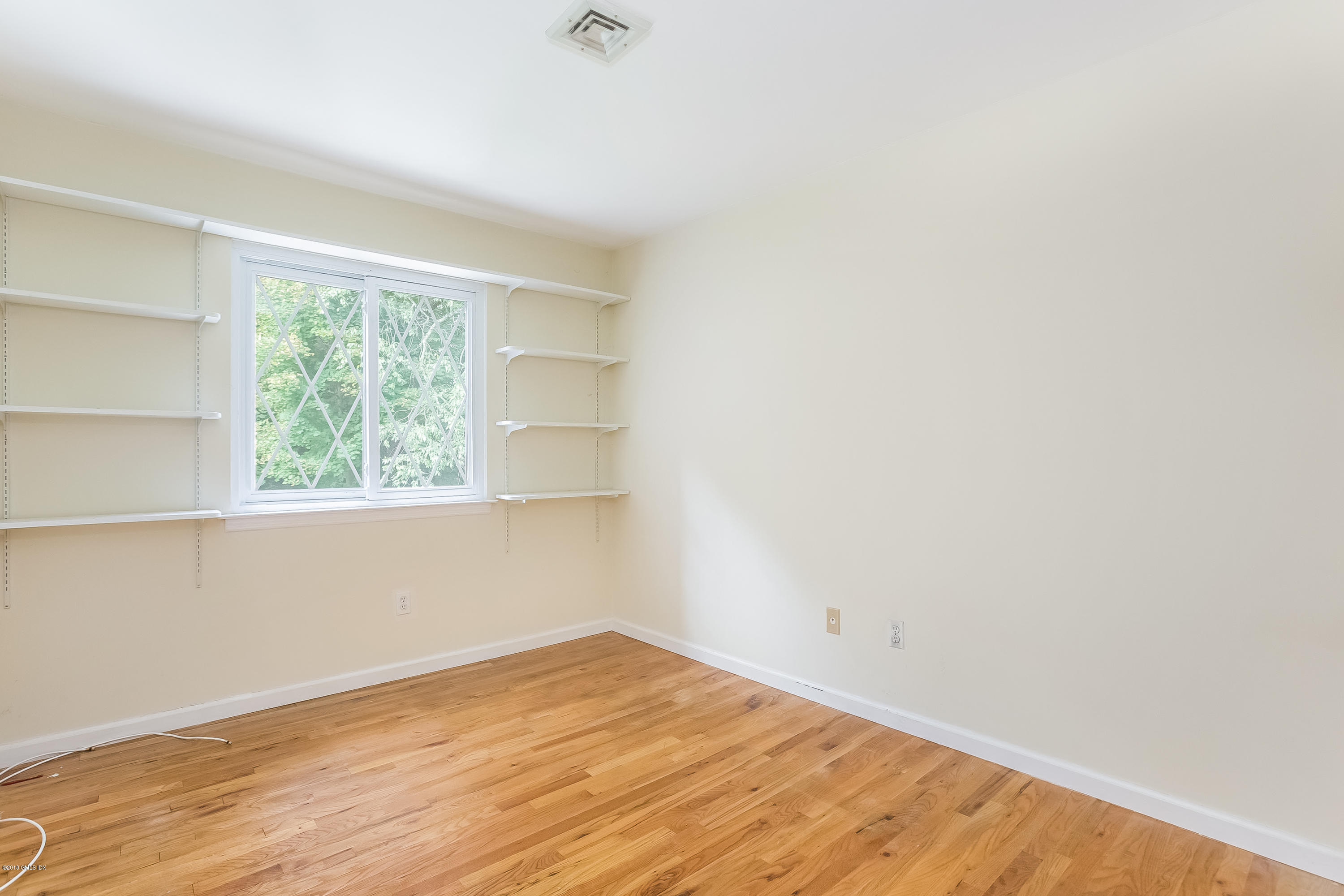 37 Sheep Hill Road, Unit 6 Riverside, CT 06878 - Photo 8 of 18 a view of empty room with wooden floor and fan