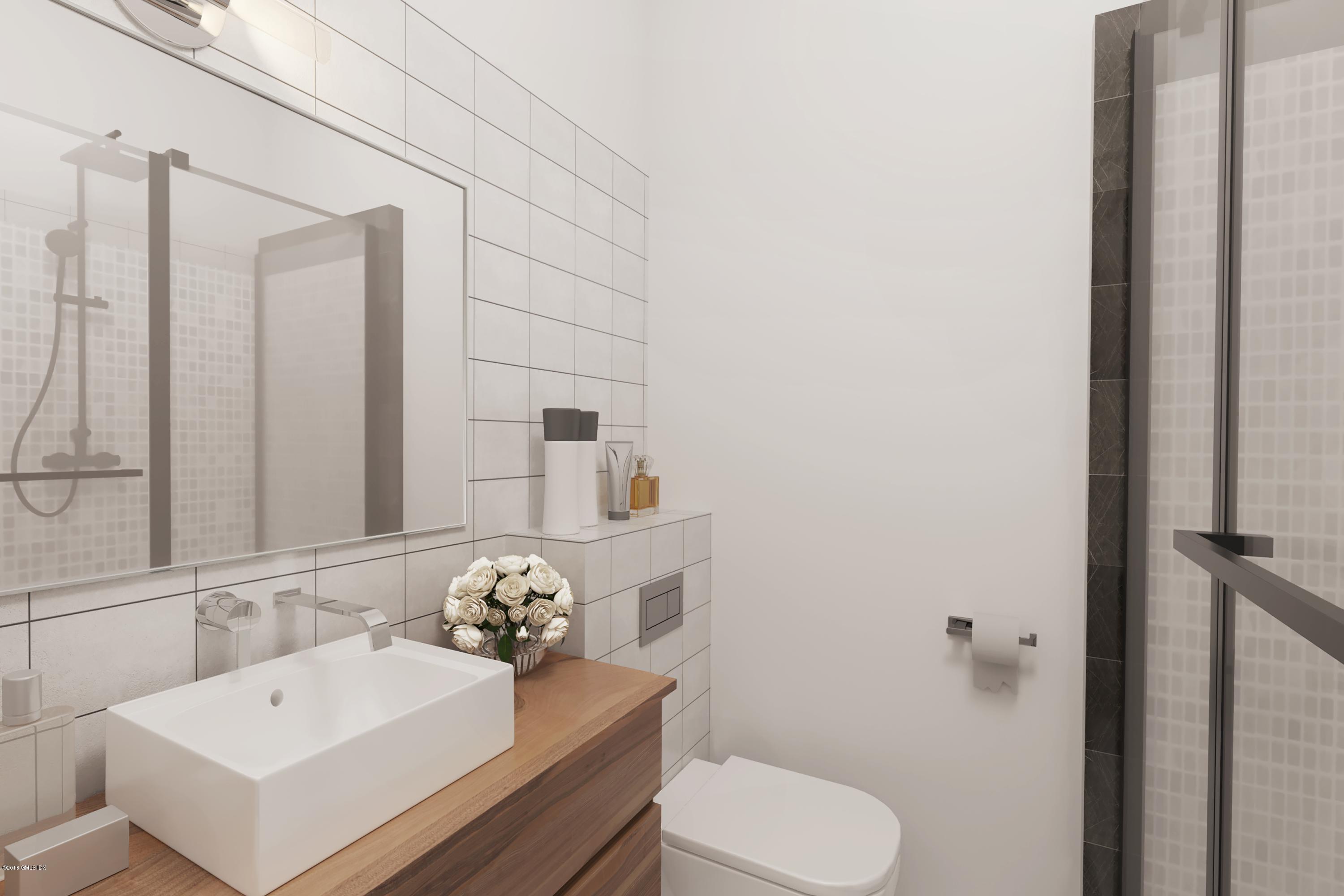 37 Sheep Hill Road, Unit 6 Riverside, CT 06878 - Photo 10 of 18 a bathroom with a sink toilet and mirror