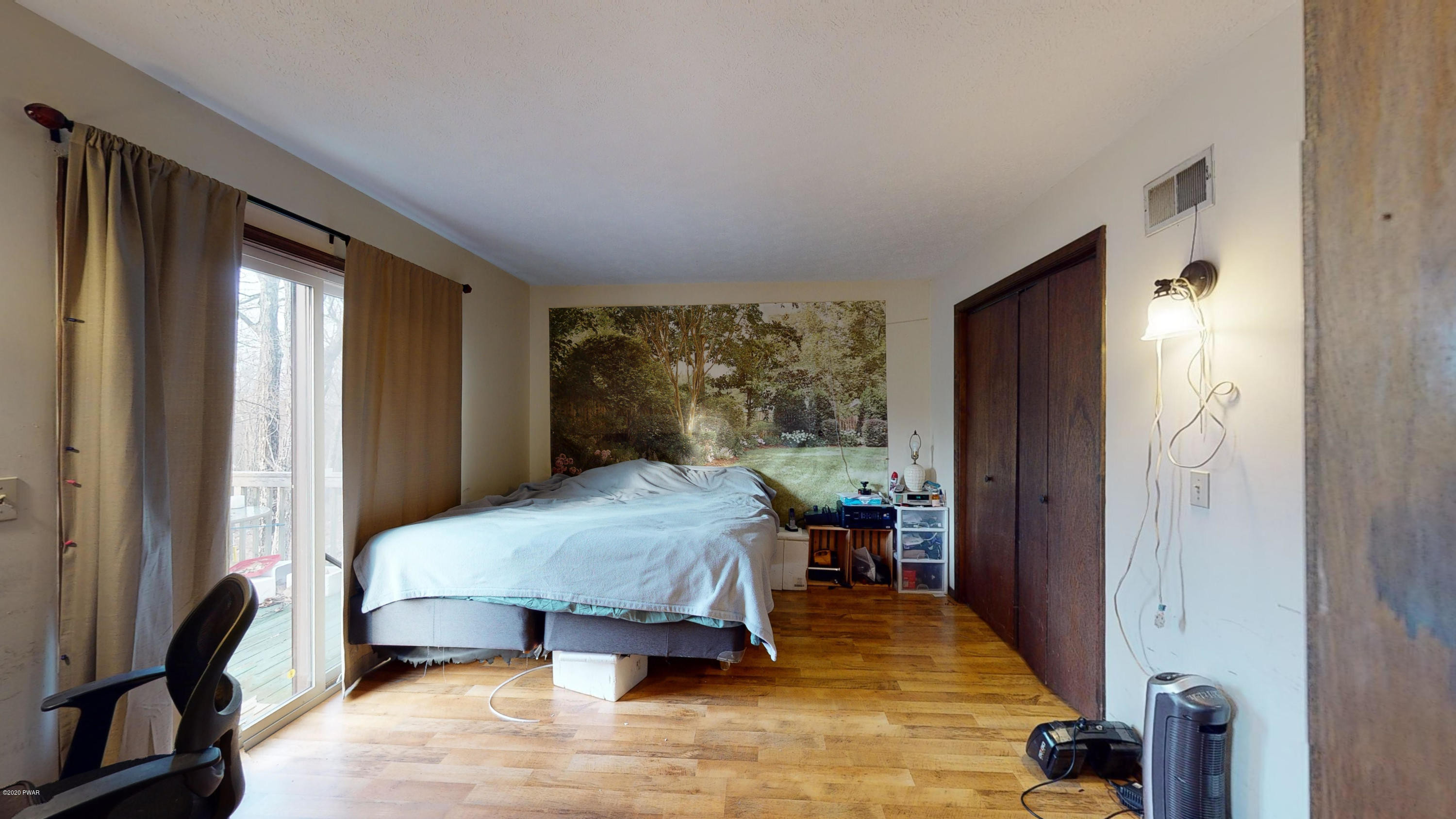 130 Maple Ridge Road Milford, PA 18337 - Photo 32 of 44 a bedroom with a bed and a large window