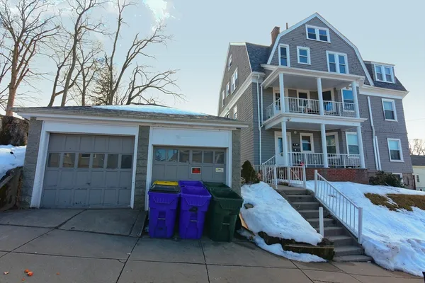 a front view of a house with outdoor seating