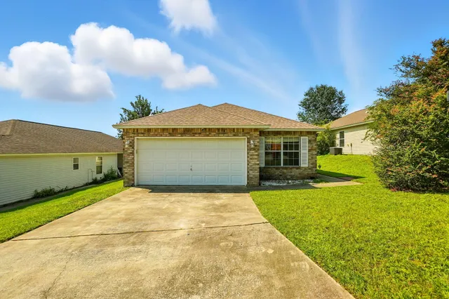 a view of a house with a backyard