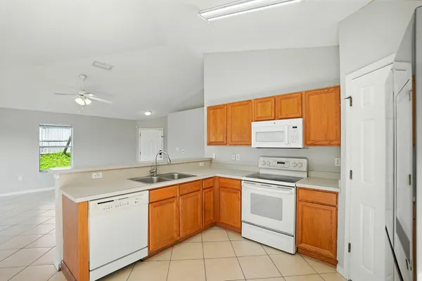a kitchen with a sink stove and cabinets