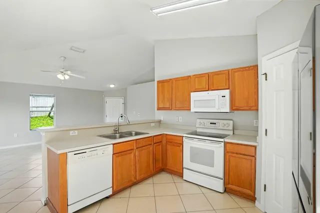 a kitchen with a sink stove and cabinets