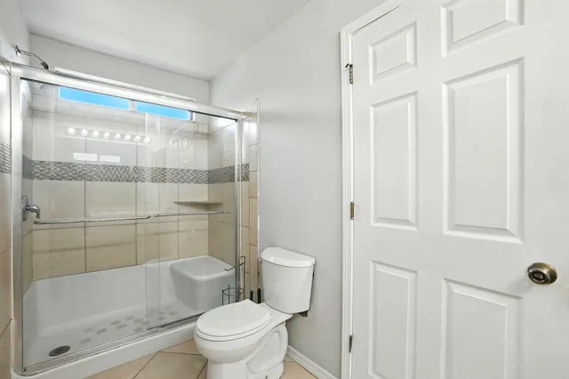 a bathroom with a toilet and a shower