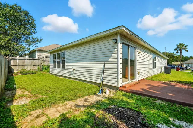 a backyard of a house with table and chairs