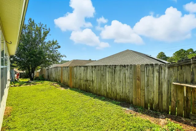a view of a backyard with pathway