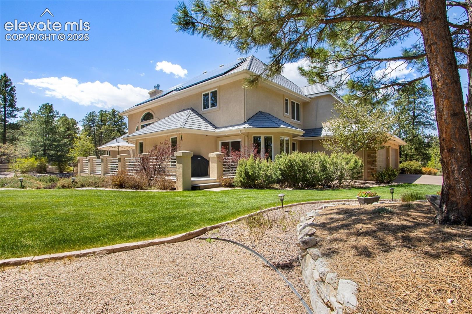 16075 Winding Trail Road Colorado Springs, CO 80908 - Photo 10 of 49 Back yard with another larger grass area and access to the deck